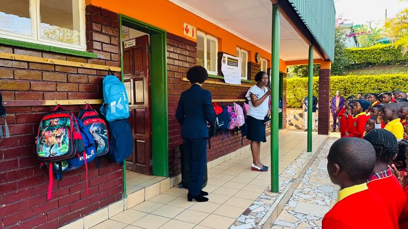 Pupils and staff gathered outside the classroom block