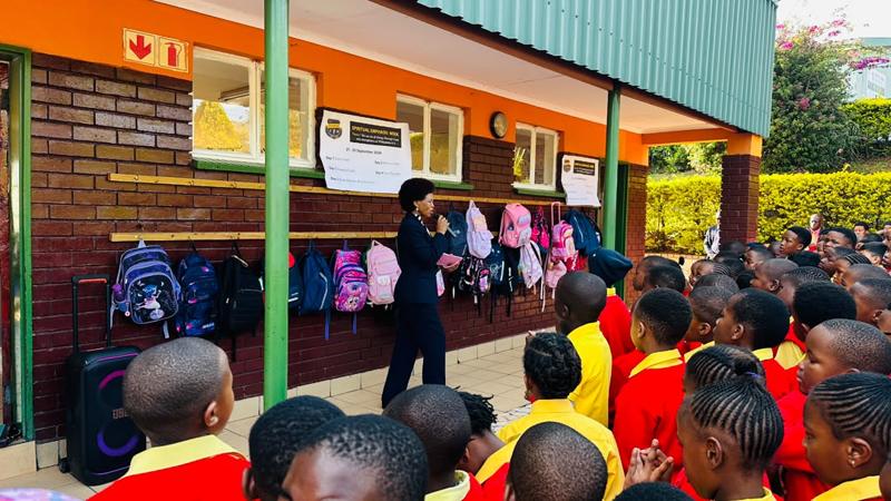A speaker addressing pupils outside the classrooms