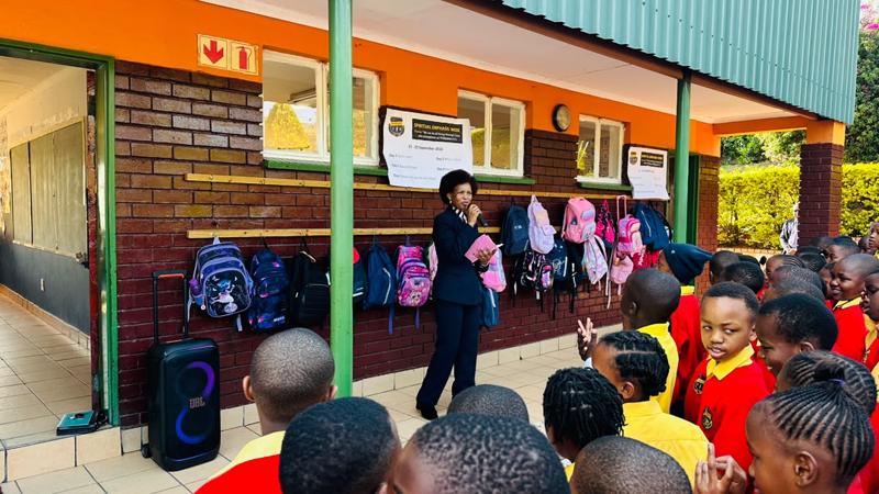 A speaker with a microphone addressing the assembled pupils
